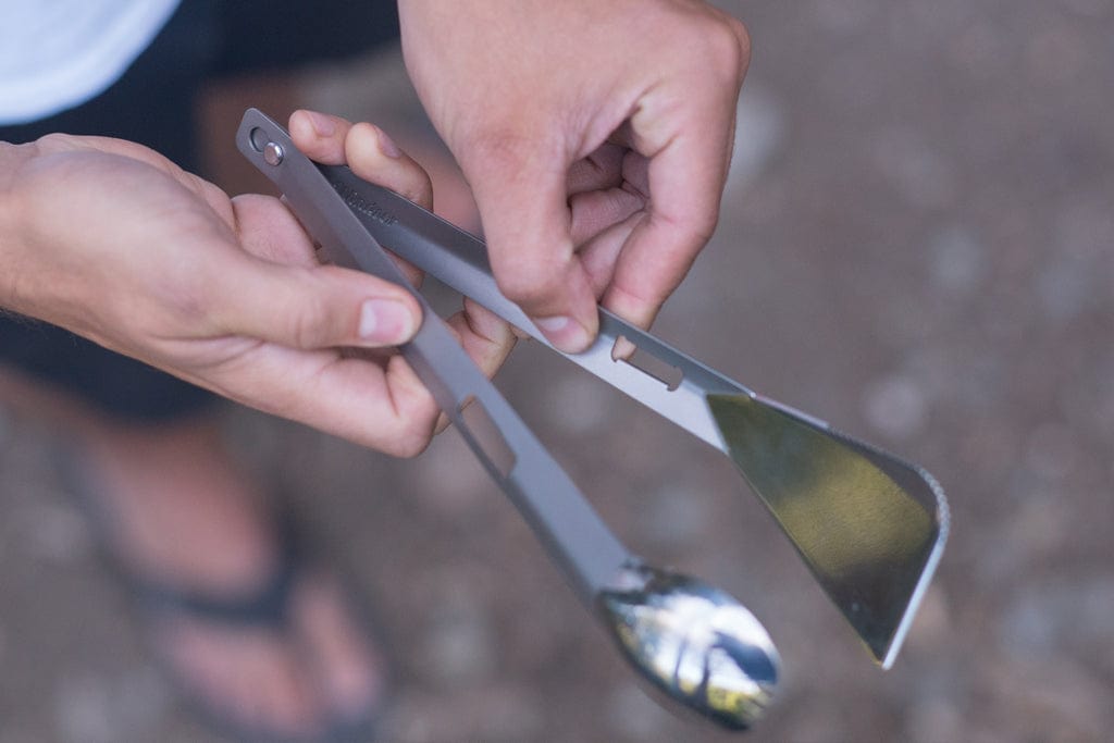 The Splitter titanium camping utensil as tongs