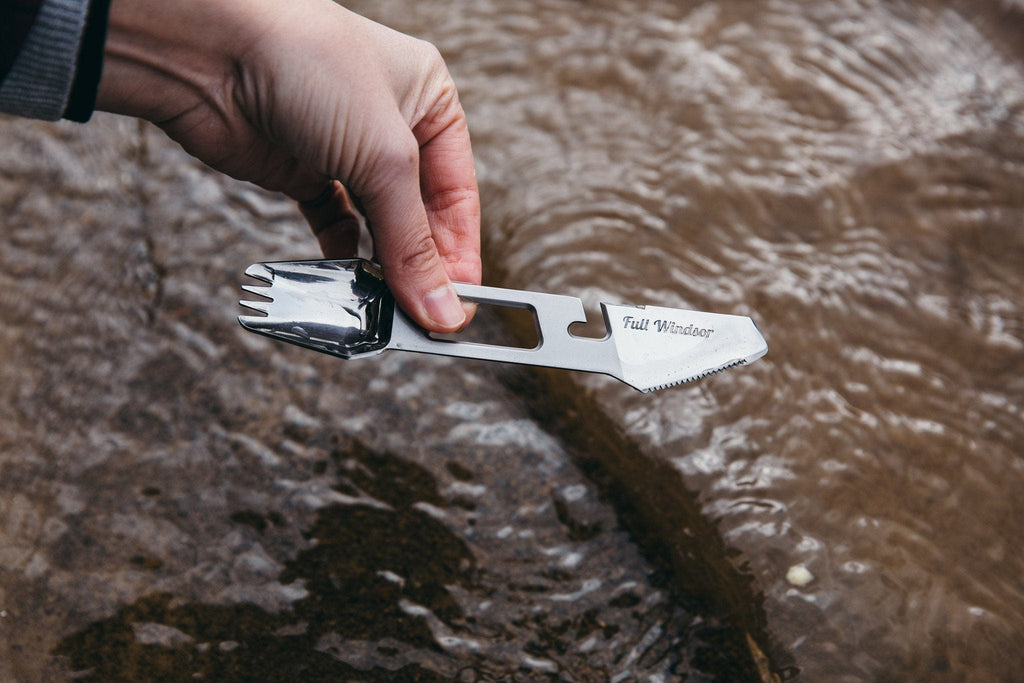 the muncher titanium camping multi utensil easy to clean polished finish being washed in stream